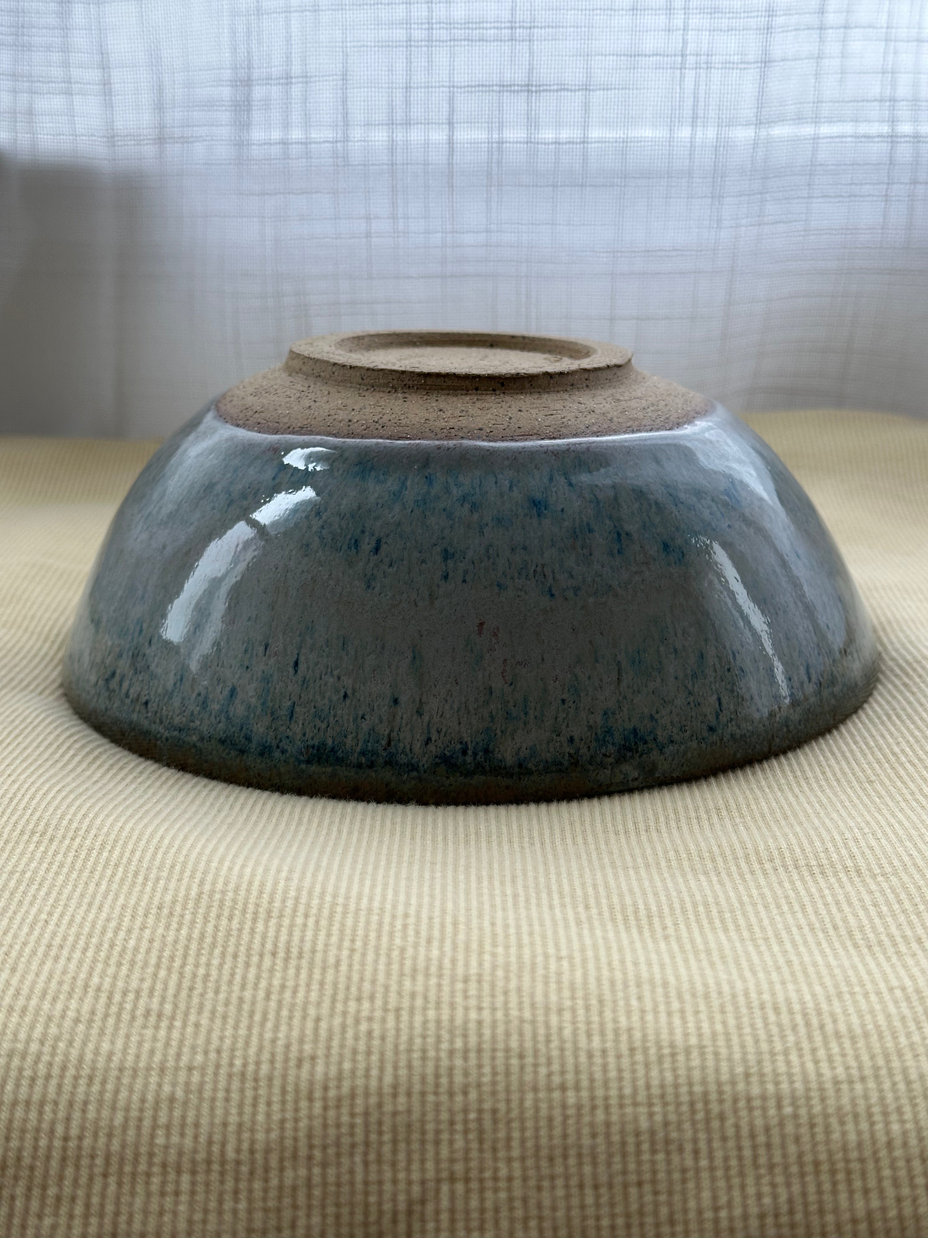 Ceramic bowl with a textured surface on a textured surface