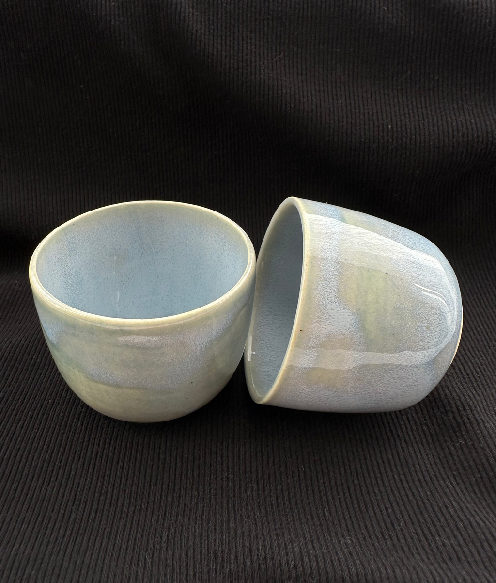 Two ceramic bowls on a black background